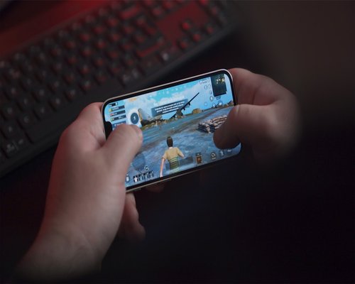 Mobile gaming interface shown on a smartphone inside an Australian technology showcase